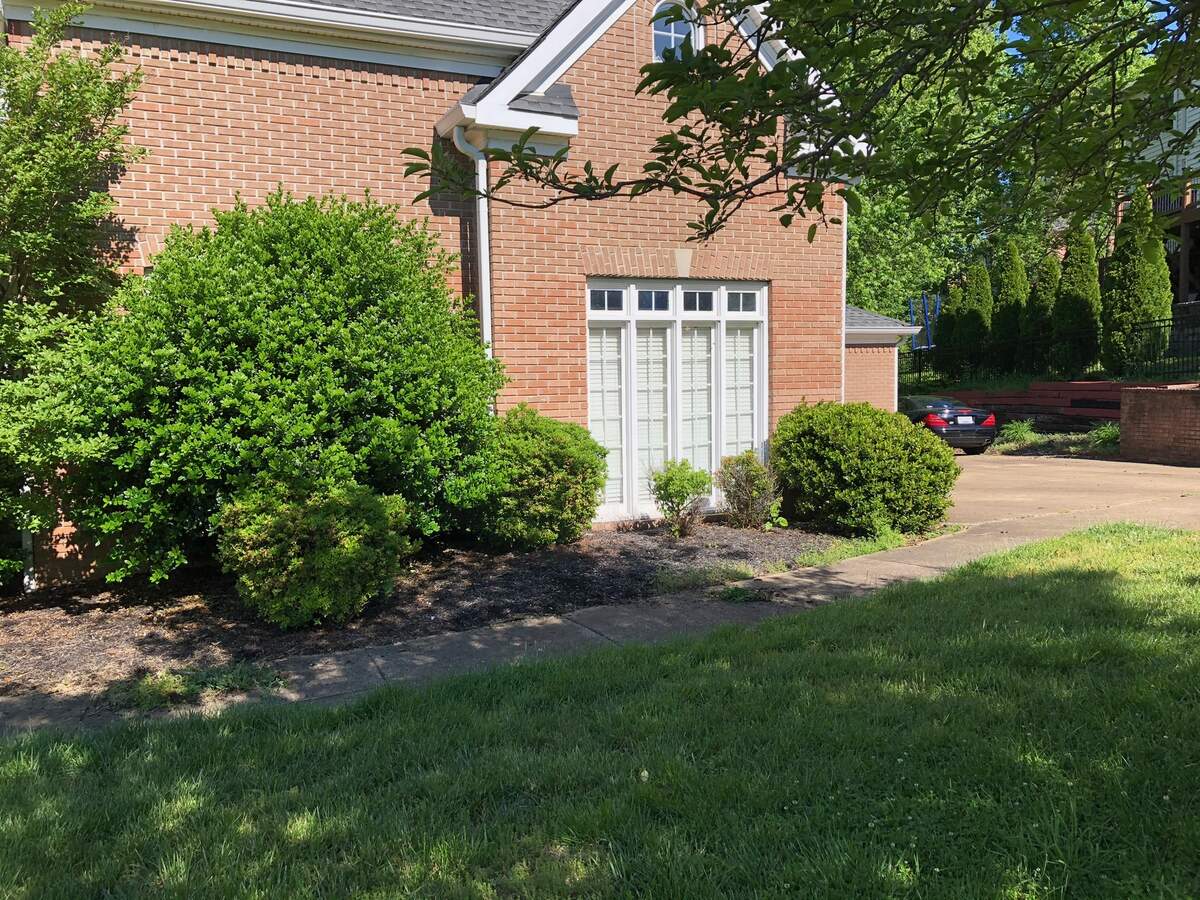 Premium pillared Chattanooga, TN home with manicured landscape by JM Landscaping