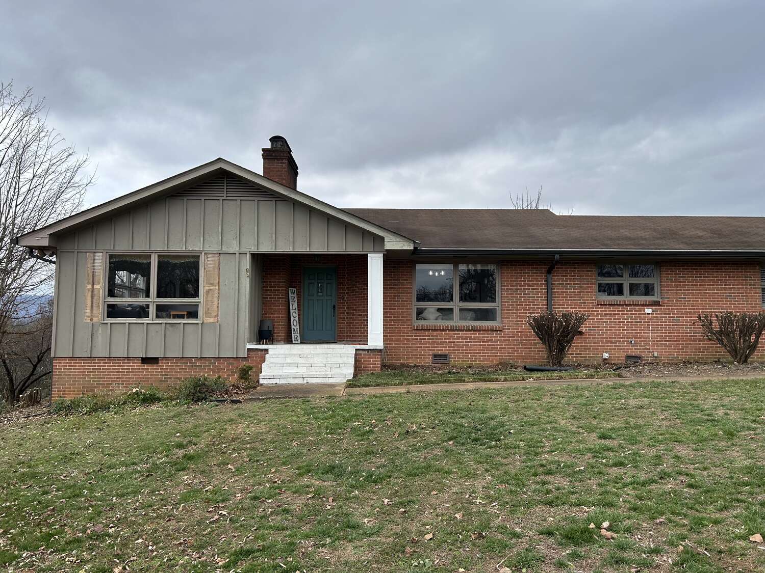 The same home after overgrown shrubs were cleared and beds cleaned up
