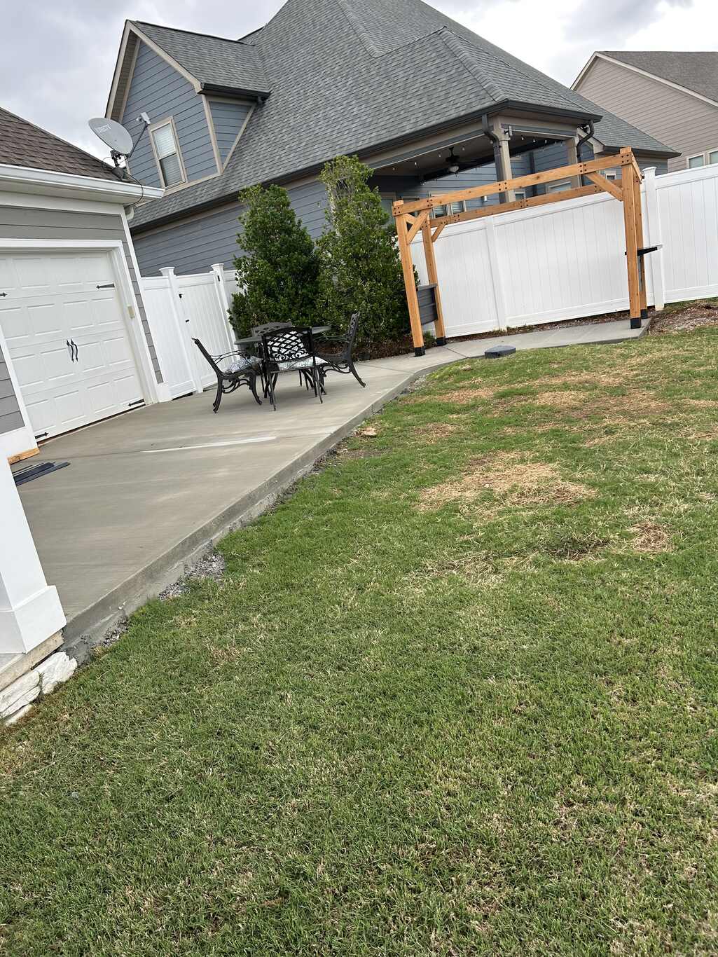 Patchy, worn backyard lawn before grading and sod
